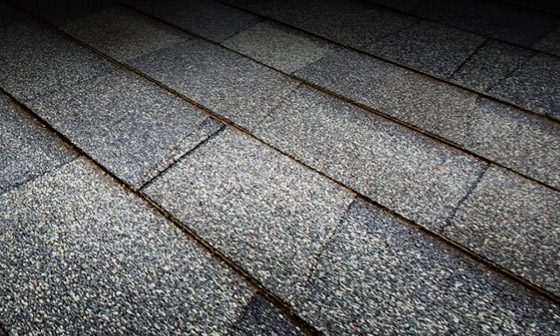 A view of a roof with high quality gray shingles.